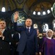Erdoğan, center, accompanied by his wife, Emine, right, waves to supporters as he walks in the Byzantine-era Hagia Sophia, an UNESCO World Heritage site and one of Istanbul's main tourist attractions, in the historic Sultanahmet district of Istanbul. The sixth-century building is now at the center of a heated debate between conservative groups who want it to be reconverted into a mosque and those who believe the World Heritage site should remain a museum.