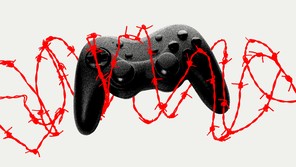 A black video-game controller wrapped in red barbed wire.
