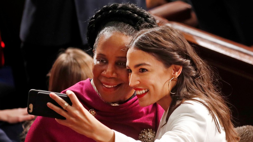 Alexandria Ocasio-Cortez takes a selfie with Representative Sheila Jackson Lee.
