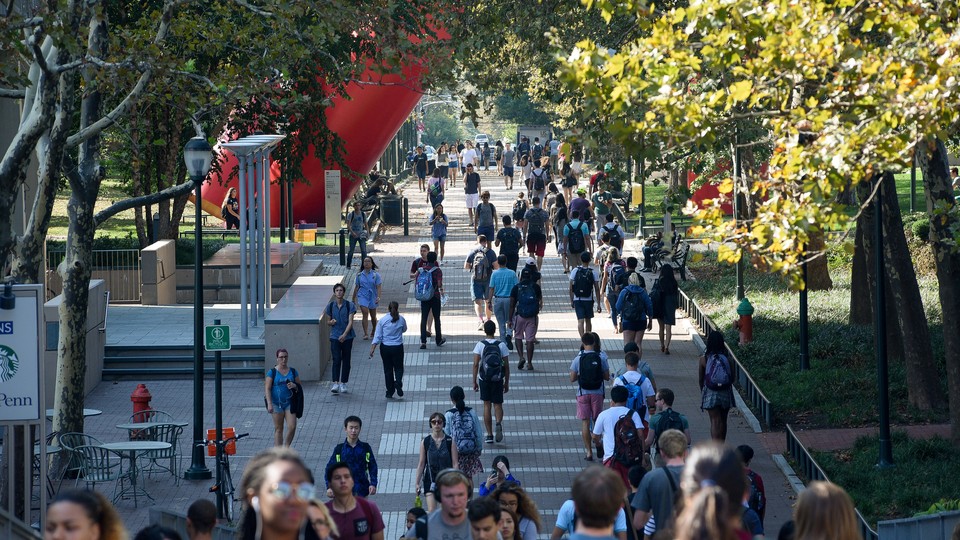 Students walking on a university sidewalk