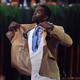 Randy Moss reacts after receiving a gold jacket during the enshrinee's gold-jacket dinner at the Canton Memorial Civic Center