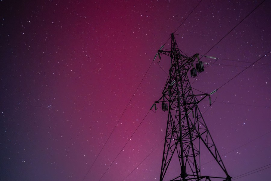 The night sky glows a shade of pinkish-purple during a display of the northern lights.
