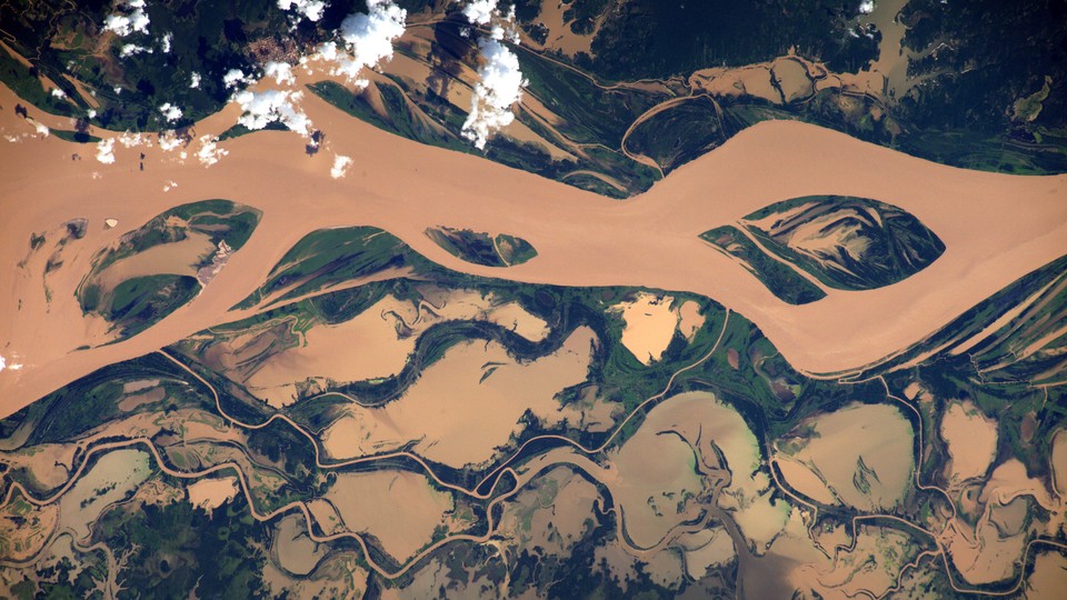 An aerial view of a muddy river.