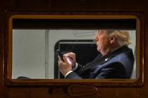 Photograph of Trump typing on a smartphone
