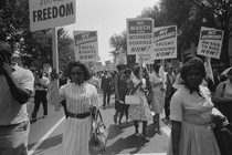 A black and white photo featuring African Americans holding signs that read "We demand equal rights now!" "We march for integrated schools now!" and "We demand decent housing now!"