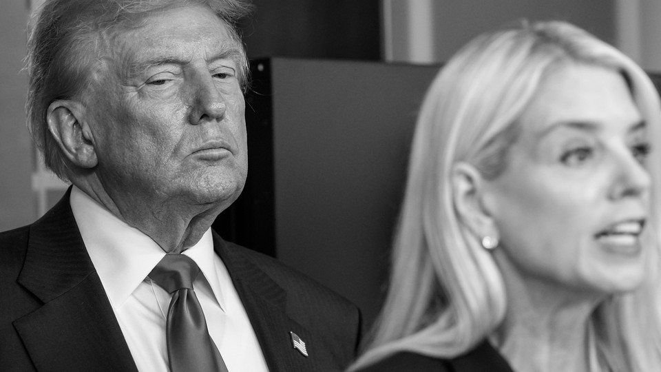 Donald Trump standing behind Pam Bondi, in black and white