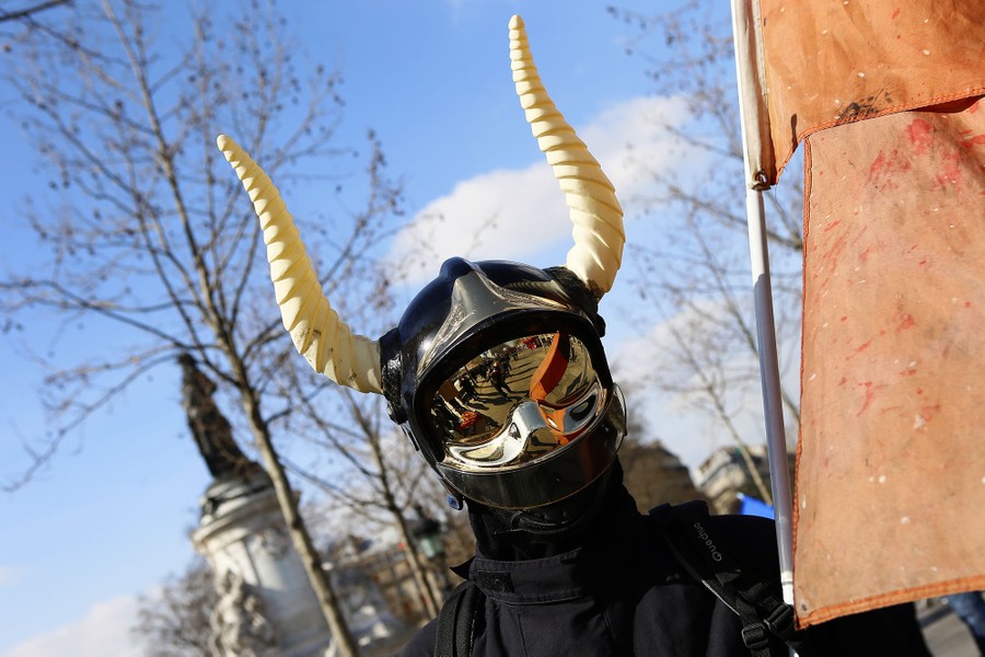 A firefighter wearing a protection helmets with horns attends a demonstration at Republique to protest against austerity measures in Paris, France, on March 14, 2017.