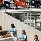 Three girls sitting under three flags
