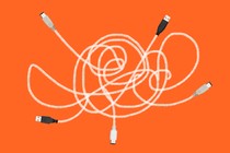 An illustration of a spaghetti of computer cables with different connectors