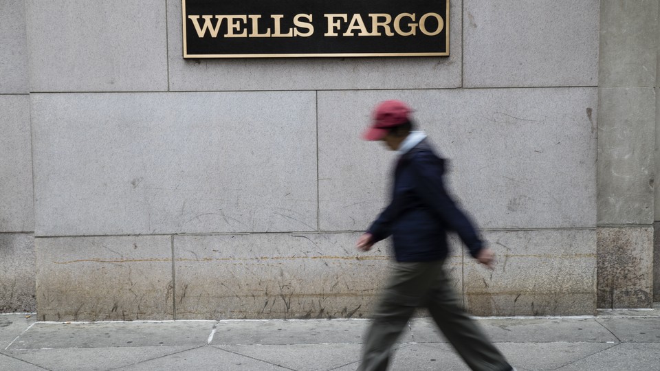 A person walks past a Wells Fargo location in Philadelphia.