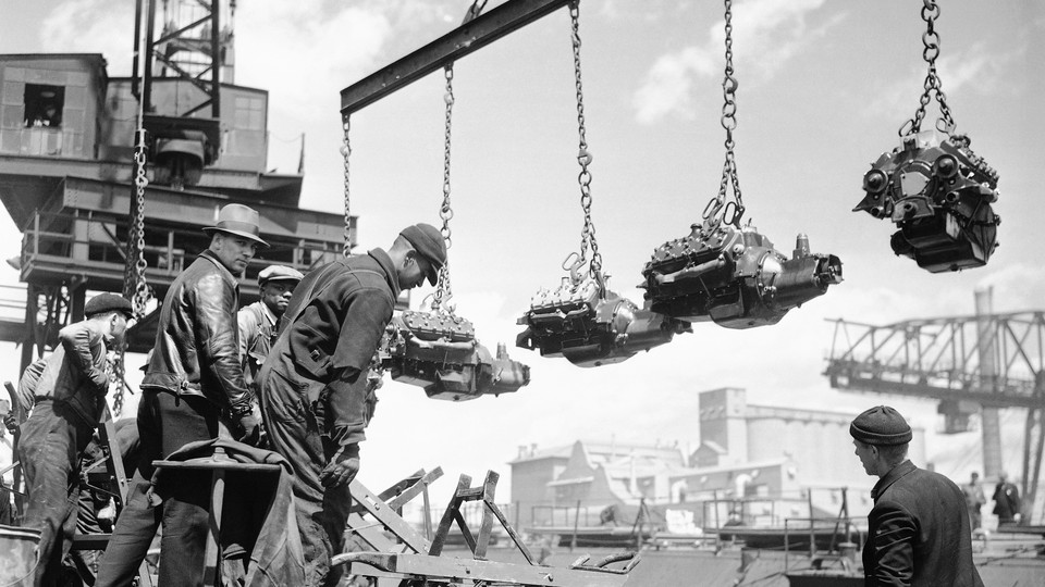 Workers unload finished engines at Ford’s River Rouge plant in 1937.