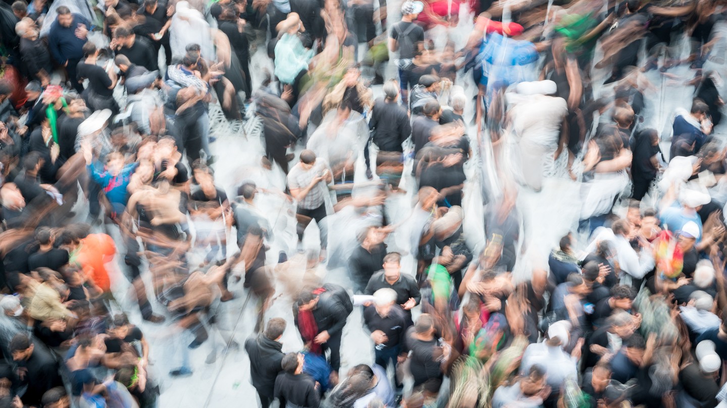 Blurry crowd of people moving around.