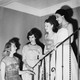 A black and white photo of four sorority sisters on a staircase