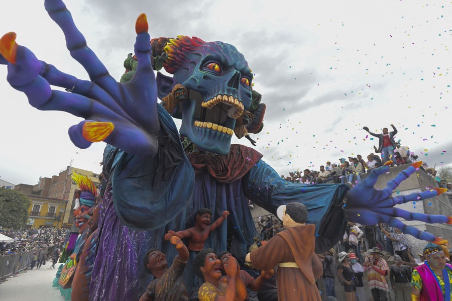 A large parade float topped with a frightening blue skull.