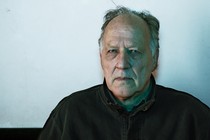 Photograph of Werner Herzog staring intently at the camera