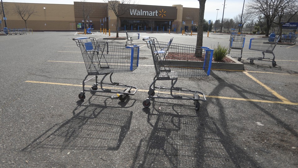 Shopping carts are shown in the parking lot of a Walmart store in California.