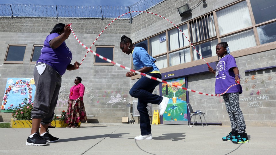 An inmate plays jump rope with her 10-year-old daughter and cousin at the Folsom Women's Facility in Folsom, California.