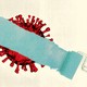 A paint roller in blue-green starts to paint over a red coronavirus.
