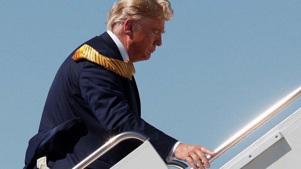 Money is seen in the back pocket of U.S. President Donald Trump as he boards Air Force One.