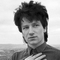 black-and-white photo of Bono with hand to chest
