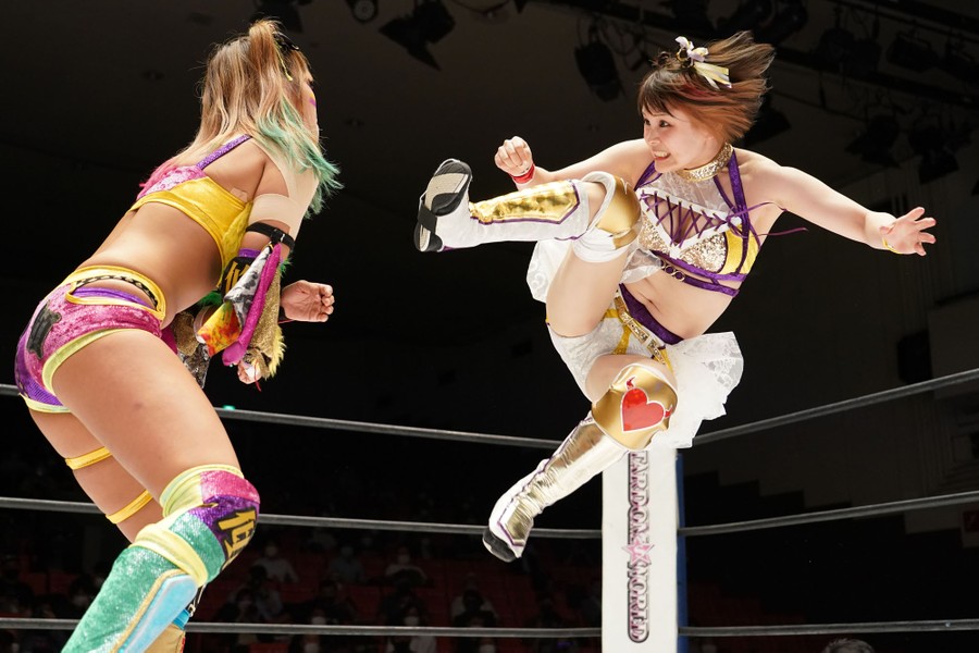 Two women square off in a wrestling match.