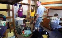 Parents help their daughter, a freshman, move into her dorm at the University of Iowa.