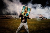 A Gaddafi supporter holds a portrait of the Libyan leader during a 2011 celebration.