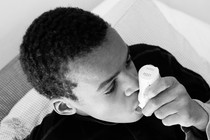 Photo of a person using an inhaler