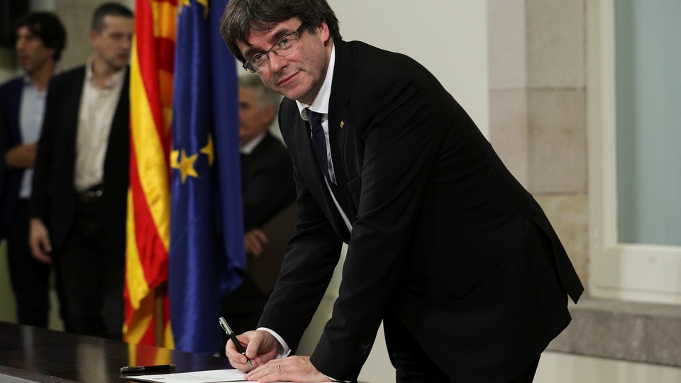 Catalan President Carles Puigdemont signs the Catalan declaration of independence.