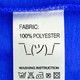 An illustration of a clothing label that says "100% polyester" above the shrug emoticon.