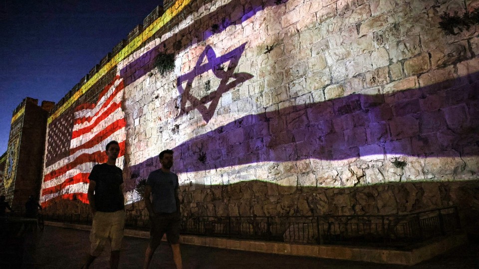 The Israeli and U.S. flags are projected against the wall of the old city of Jerusalem during the visit of President Biden.