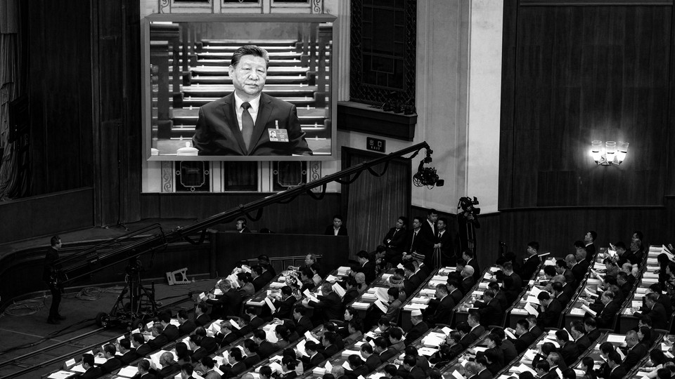 Black-and-white photograph of a crowd watching Xi Jinping speak at a podium