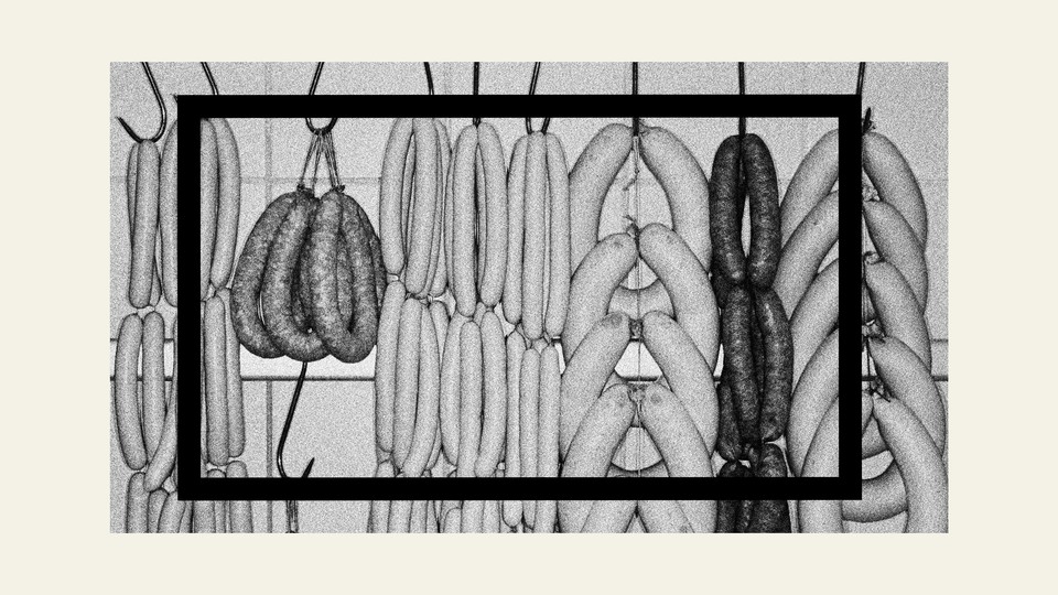 A black-and-white image of sausage links hanging on a rack