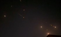 Iranian projectiles streak across the night sky.