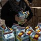 A volunteer prepares food to b​e delivered during a food dist​ribution for casino w​orkers laid off due to the coronavirus pan​demic at the Harbor Square Mal​l in Egg Harbor Township, New Jesery.