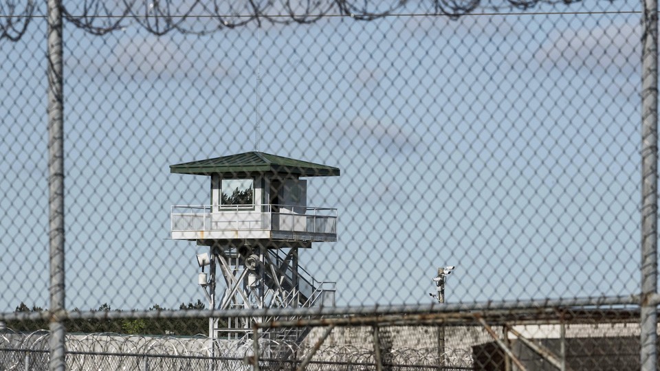 A jail watchtower seen through a fence
