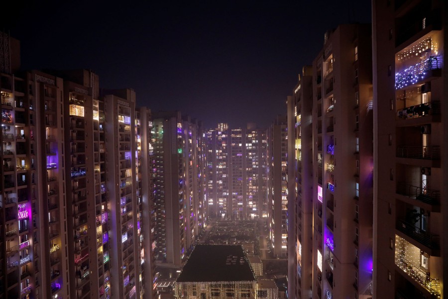 Balconies of apartments are illuminated for a festival.