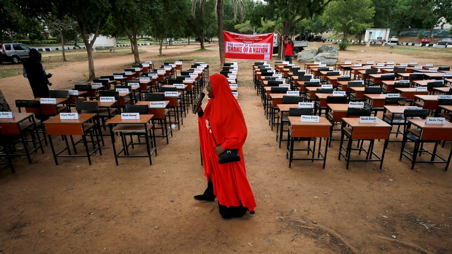 A woman holds a microphone at an event marking the anniversary of the Chibok kidnapping