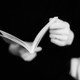 A black-and-white photo of a person reading a book