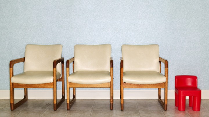 Adult chairs and a child's chair in a clinic waiting room