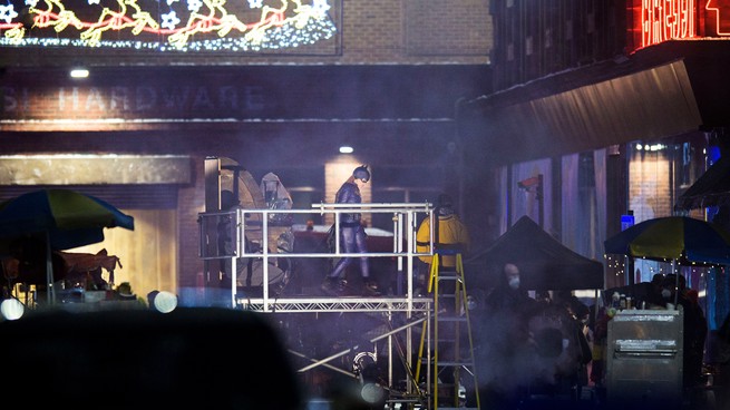 Leslie Grace as Batgirl standing on a platform during filming