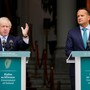 British Prime Minister Boris Johnson and his Irish counterpart, Leo Varadkar, stand behind lecterns to address the press.