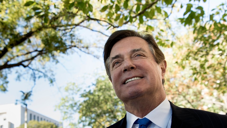 Paul Manafort is photographed smiling as he leaves the E. Barrett Prettyman United States Court House after being charged on October 30, 2017