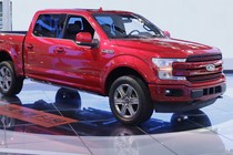 A red Ford four-door pickup truck