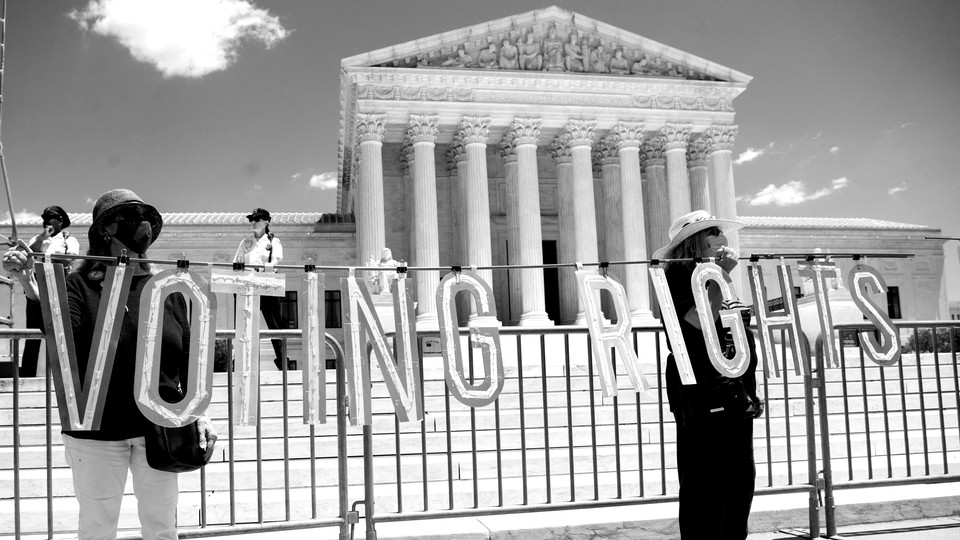 People protest in favor of voting rights outside of the Supreme Court in Washington, D.C.