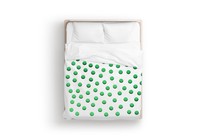 a bed with lots of green dots on it