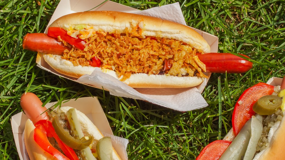 Three hot dogs on the grass