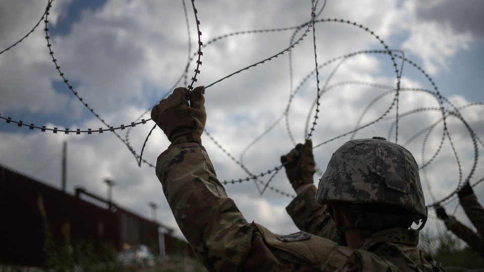 U.S. Army soldiers install concertina wire along the U.S.-Mexico border in Hidalgo, Texas.