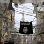 An Islamic State flag hangs amid electrical wires over a street in Lebanon.