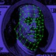 An illustration of U.S. currency with the face being mapped for facial recognition